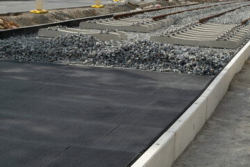 pneumatic pad at a construction site of tram tracks in a European city street. Made from recycled rubber of old tires. © ArieStudio