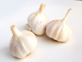 Heads of garlic on a white background
