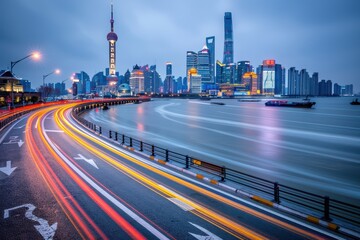 Fototapeta premium Shanghai cityscape at night with illuminated skyscrapers and vibrant light trails along the waterfront road, capturing a modern urban vibe.