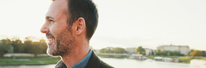 Obraz premium Man walking along the embankment of the river