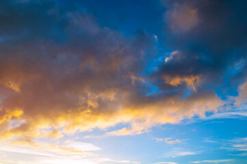 Obraz premium Blue sky background - picturesque colorful clouds lit by sunlight