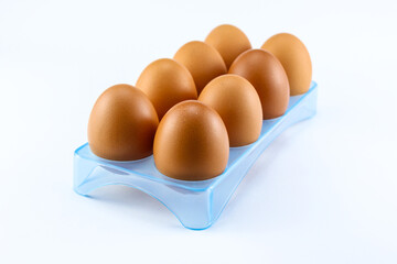 Chicken eggs in an egg holder on a white isolated background are suitable for photo illustrations