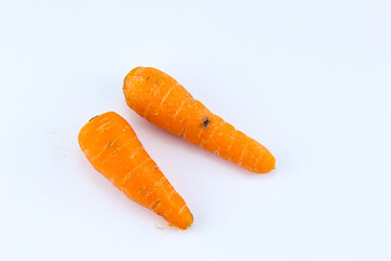 two fresh orange carrots on a white isolated background