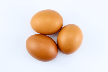 group of three raw asian chicken eggs on white isolated background