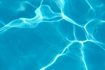 Blue pool water with sunlight reflections