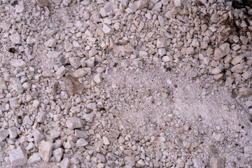 A pile of rocks and gravel with a few small rocks scattered around