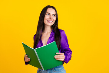 Photo of positive smiling lady read open notebooks look profile side empty space isolated bright color background