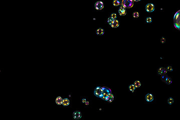 Soap bubbles isolated on a black background. Copy space.