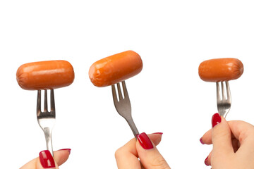 Small sausage on a fork in woman hand isolated.