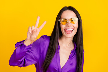 Photo of positive lady wear sunglass wink make v sign isolated bright color background