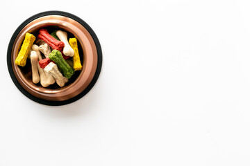 Food and treats for pets. Bowl full of dog chew bones