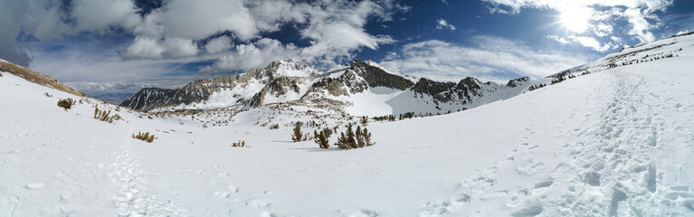 A snow covered mountain range with a clear blue sky