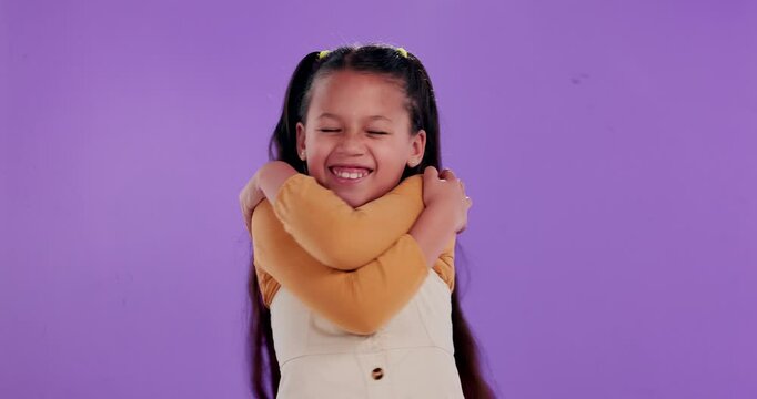 Hug, portrait and child in studio with self love, smile or identity development for happy kid. Care, empowerment and girl with positive attitude, affirmation or confident mindset on purple background