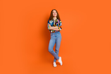 Photo of lovely cute nice girl wear trendy print clothes look empty space isolated on vivid orange color background