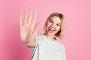 Portrait of cheerful positive friendly girl with bob hairstyle wear white t-shirt give you highfive isolated on pink color background