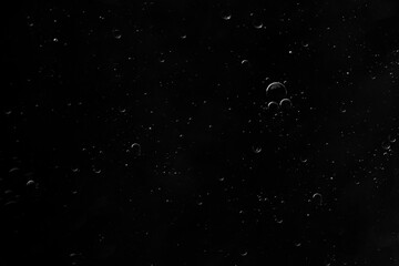 Air bubbles in the water background.Abstract oxygen bubbles in the sea.Water bubbles isolate on black background.Black and white tone style.