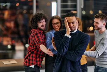 A group of young business people have fun playing interesting games while taking a break from work in a modern office. Selective focus 