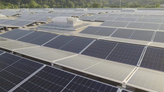 Rooftop solar panels system station aerial view. Moving slowly above PV modules array drone shot. Alternative green energy power plant. Ecological electricity station with no people outdoors