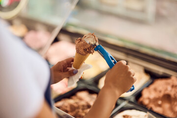 Close-up of a cone with a scoop of ice cream on it.