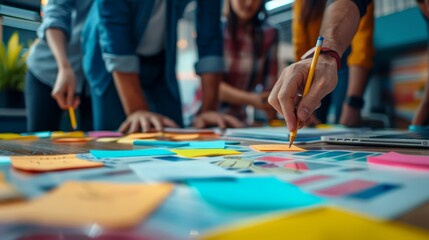 Obraz premium Team collaborating on project with colorful sticky notes and charts in modern workspace symbolizing innovation and cooperation