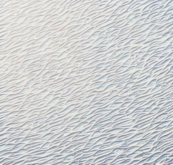 Obraz premium Stone mosaic background. White and beige stonewall. Rock texture with waves. Close-up. Rough Stone surface. Nature backdrop with empty copy space. Minimalist design 