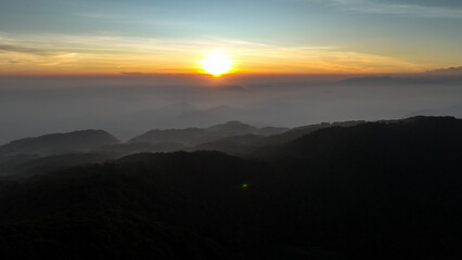 Aerial view of the sky above the hill of Mount Kencana, with beautiful clouds and mist covering the surroundings