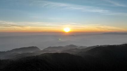 Aerial view of the sky above the hill of Mount Kencana, with beautiful clouds and mist covering the surroundings