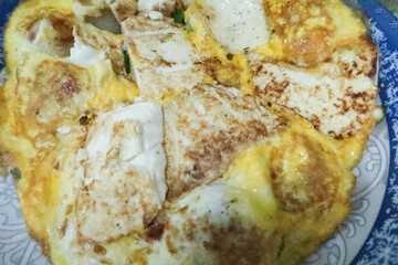 close up of Hong Kong style homemade fried egg and bean curd tofu placed in a blue and white plate