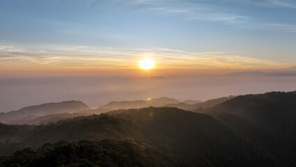 Aerial view of the sky above the hill of Mount Kencana, with beautiful clouds and mist covering the surroundings