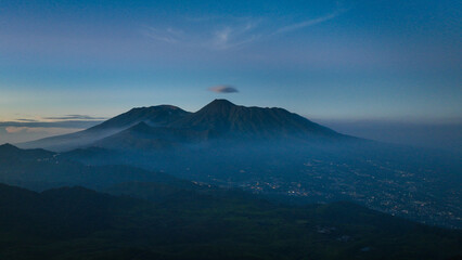 Fototapeta premium Aerial view of Gede Pangrango Mount from the top of Mount Kencana, with bright blue skies and covered in beautiful mist and clouds Bogor&nbsp;-&nbsp;West&nbsp;Java Indonesia
