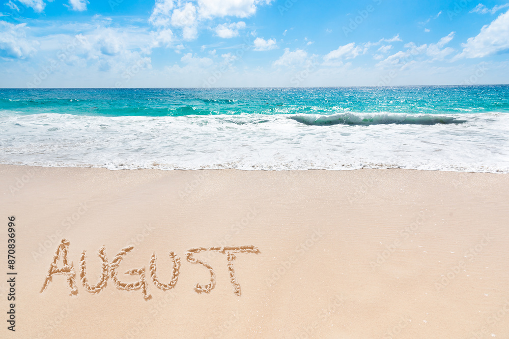 Poster August written on a tropical beach with golden sand