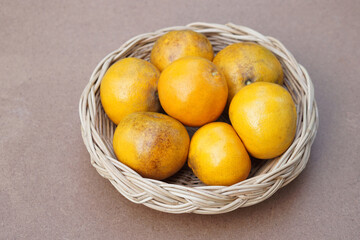 Organic orange fruits in rattan basket. Seasonal Thai fruit in Nan Province, Thailand named 