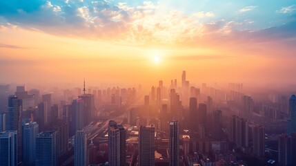 Fototapeta premium A vibrant sunrise over a city skyline, casting warm light over skyscrapers and hazy atmosphere.