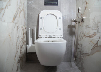 Modern toilet bowl in the toilet in foam and detergent. The concept of washing and cleaning the...