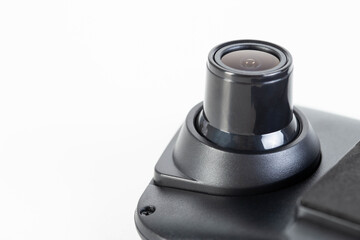 DVR camera eye on a white background, maximum video recording resolution and frame rate. Car mirror with video recorder. Copy space for text