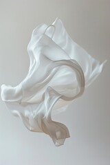 Fototapeta premium A white cloth is seen flying through the air, perhaps caught up in a breeze or tossed by someone
