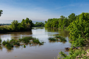 Republican River in Cloud County, Kansas, north of the city of Concordia. Blue sky and clouds in distance.  
