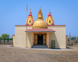 Colorful temple outside the main city with clear blue sky background in Kalamb, Yavatmal, India.