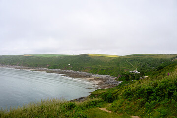 the South West Coast path along the Rame Peninsula in Mount Edgcumbe Country Park Cornwall England on a misty summer day