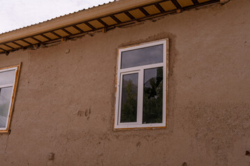 A window with a bird in it is reflected in the window