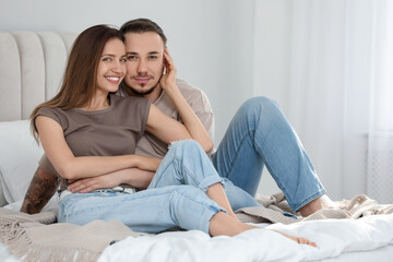 Fototapeta premium Family portrait of lovely couple on bed at home