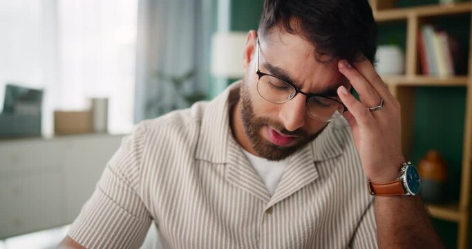 Home office, headache and man with pain, paperwork and planning for project, copywriting and stress. Bankruptcy, apartment and entrepreneur with documents for loan, rejection letter and depression