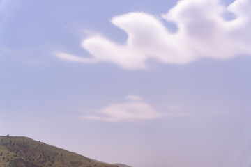 A mountain with a cloud in the sky