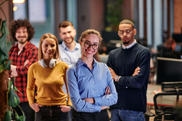 Fototapeta premium Portrait of successful creative business team looking at camera and smiling. Diverse business people standing together at startup. Selective focus 