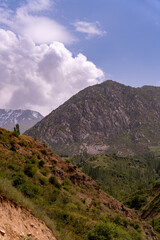 A mountain range with a cloudy sky in the background