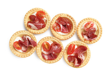 Delicious canapes with jamon, cream cheese and cherry tomatoes isolated on white, top view