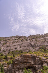 A mountain with a cloudy sky in the background