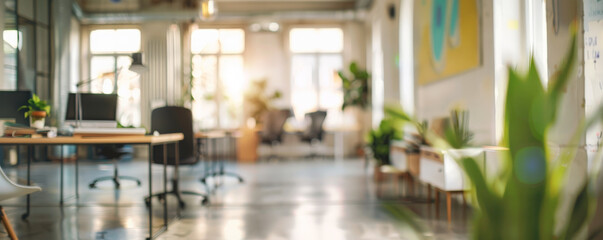 A blurred bright office background with open desks, vibrant artwork, and natural light, creating a dynamic and inspiring workspace.