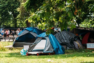 Tents and Tarps Set Up in a Green Urban Park near Hyde Park, London