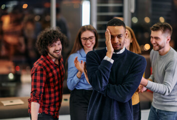 A group of young business people have fun playing interesting games while taking a break from work in a modern office. Selective focus 